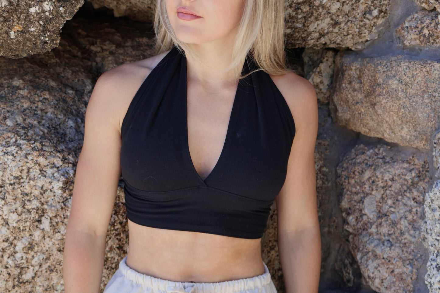 Black halter wrap top for women in stretchy cotton with tie back and cropped design