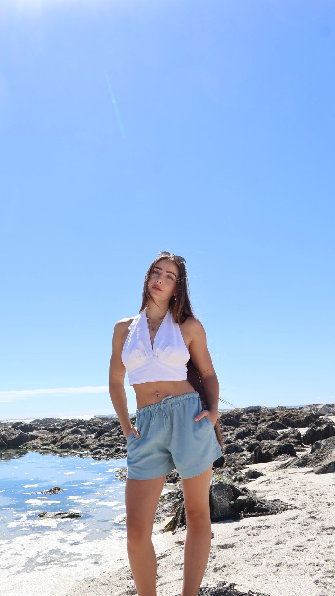 Soft women’s linen shorts with relaxed fit, styled with a linen halter wrap top.
