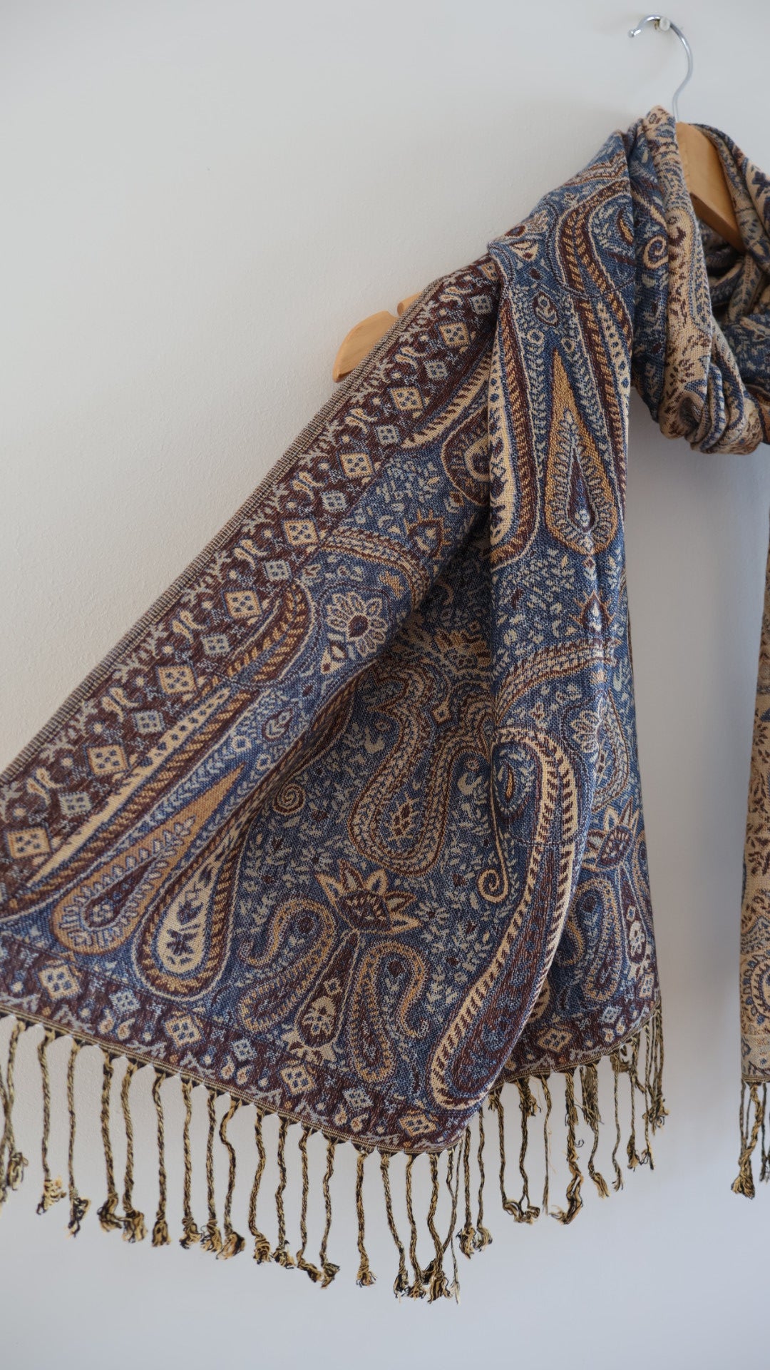 Blue Maroon boho festival pashmina scarf draped on a hanger, side 1.