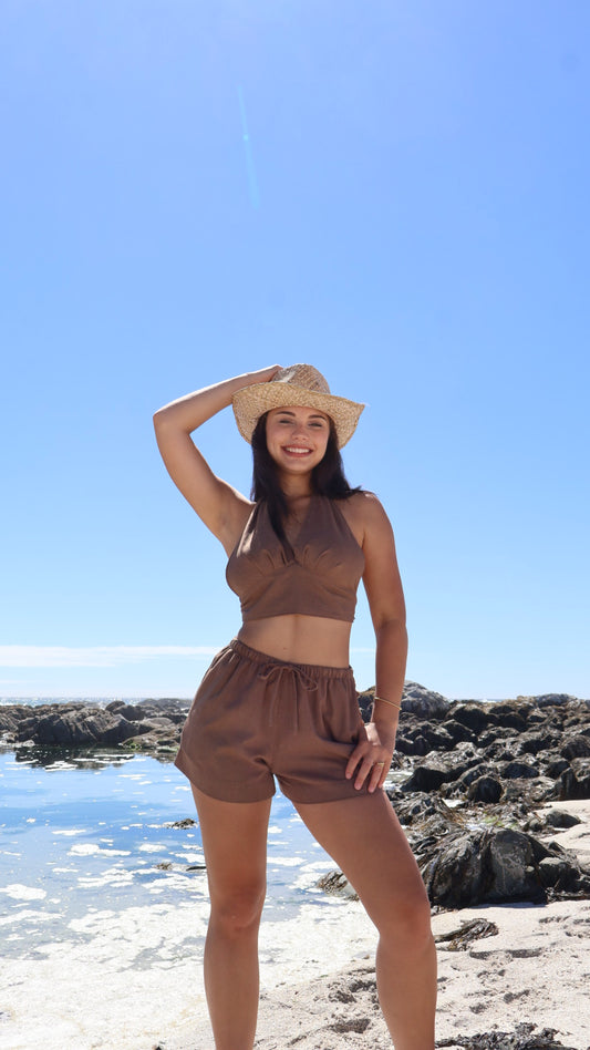 Soft women’s linen shorts with relaxed fit, styled with a linen halter wrap top.