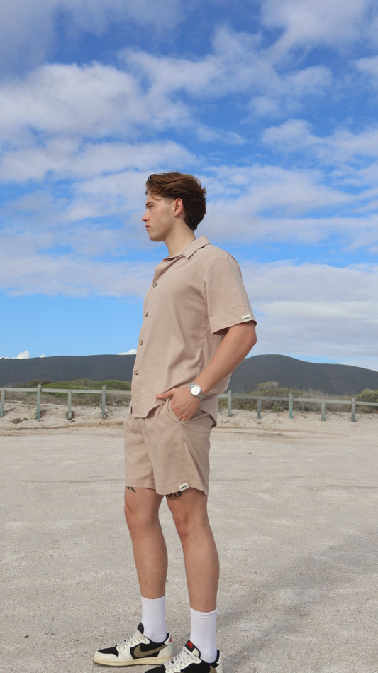 Natural linen button-up shirt for men with short sleeves, relaxed fit, and shell buttons