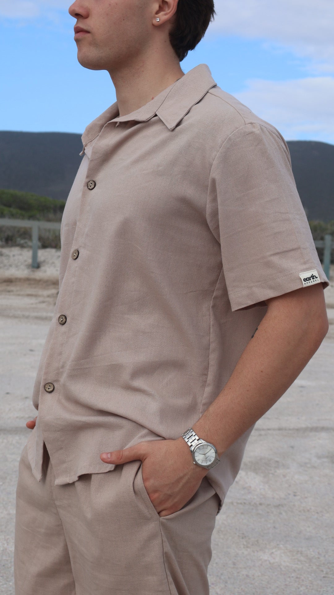 Natural linen button-up shirt for men with short sleeves, relaxed fit, and shell buttons