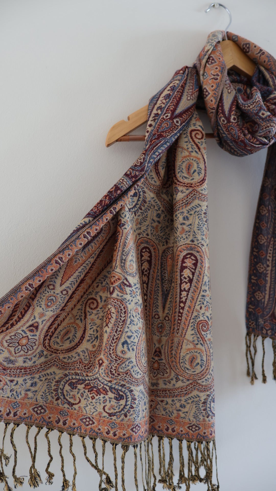 Maroon Blue boho festival pashmina scarf draped on a hanger, side 2.