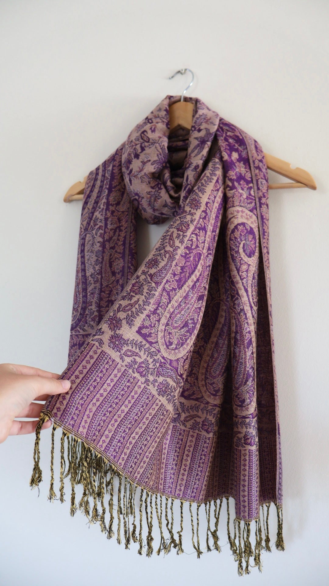 Purple boho festival pashmina scarf draped on a hanger