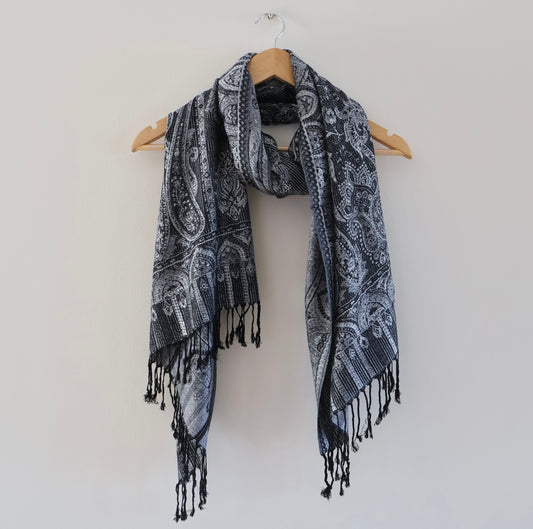 Black and white boho festival pashmina scarf draped on a hanger