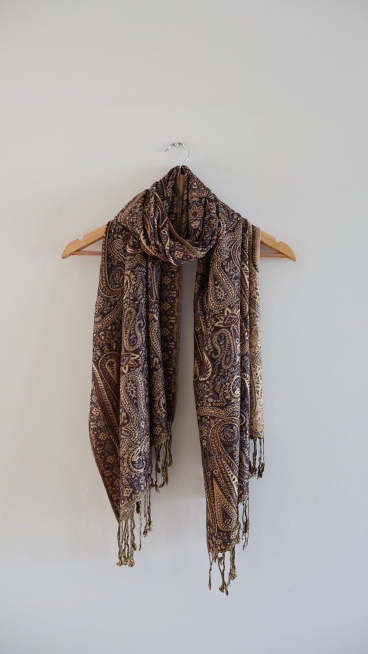 Brown boho festival pashmina scarf draped on a hanger
