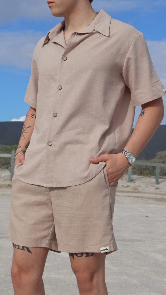Natural linen button-up shirt for men with short sleeves, relaxed fit, and shell buttons