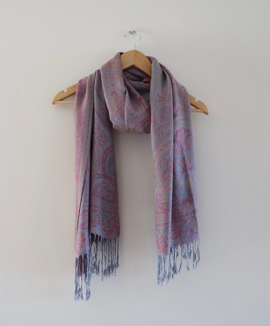 Light grey boho festival pashmina scarf draped on a hanger