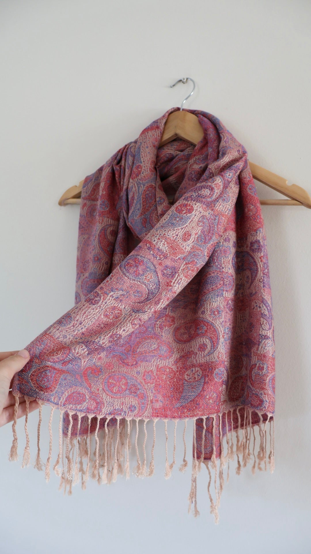 Paisley Pink boho festival pashmina scarf draped on a hanger
