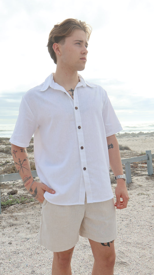 Natural linen button-up shirt for men with short sleeves, relaxed fit, and shell buttons