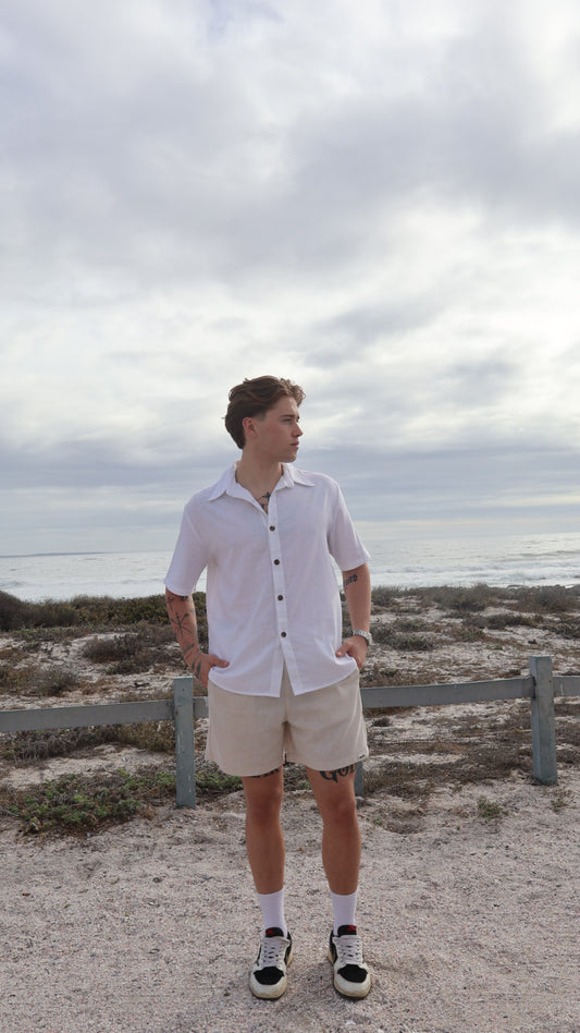 Natural linen button-up shirt for men with short sleeves, relaxed fit, and shell buttons